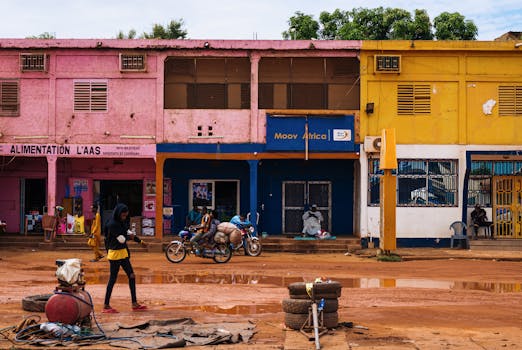 Vibrant city street in Africa with colorful buildings and local activity.
